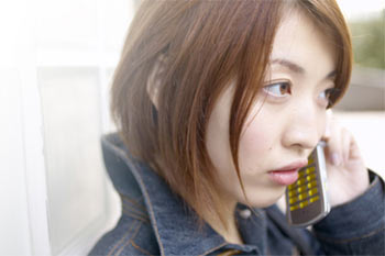 A woman making a phone call on a cell phone.
